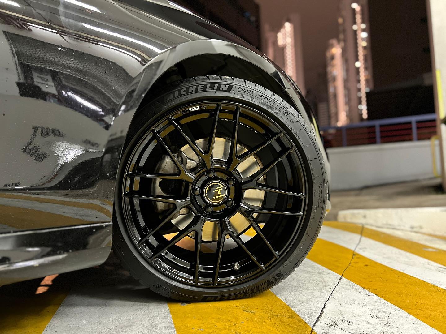 Black mesh rim fitted with Michelin tyre at night
